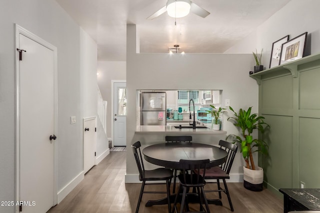 1600 N Saba St Unit 143, Chandler, AZ 85225 - dining area with wood finished floors, a ceiling fan, and baseboards