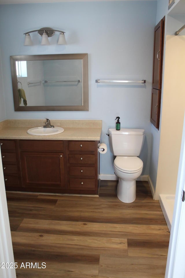 235 N 61st Pl, Mesa, AZ 85205 - bathroom featuring toilet, vanity, wood finished floors, a shower, and baseboards