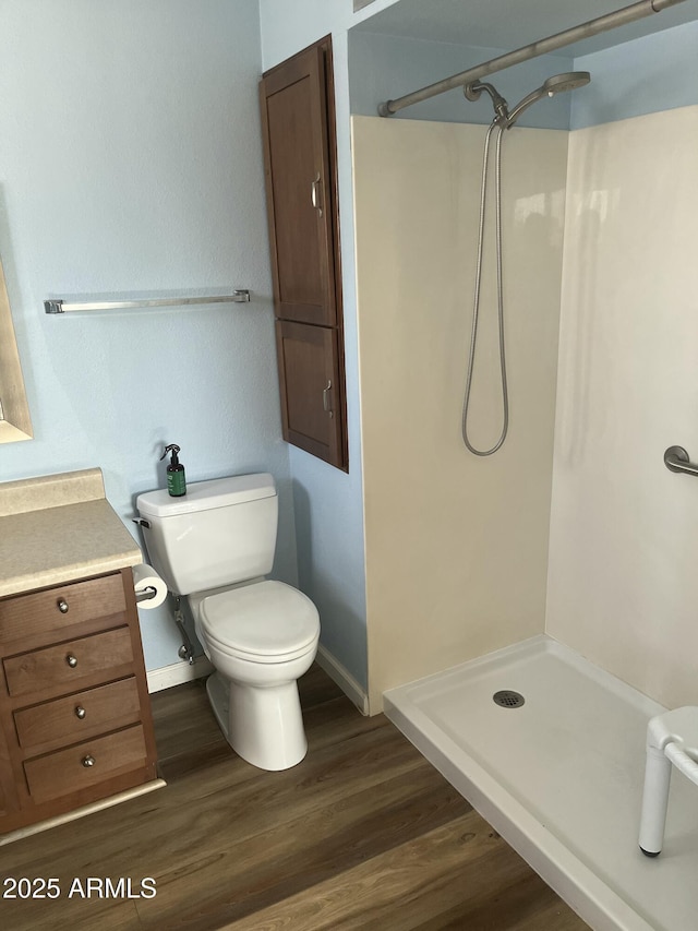 235 N 61st Pl, Mesa, AZ 85205 - bathroom with a stall shower, toilet, wood finished floors, vanity, and baseboards