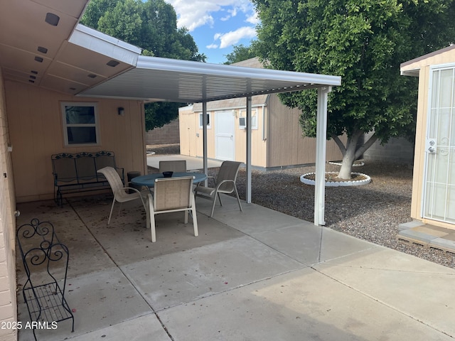 235 N 61st Pl, Mesa, AZ 85205 - view of patio with a shed, outdoor dining area, an outbuilding, and fence