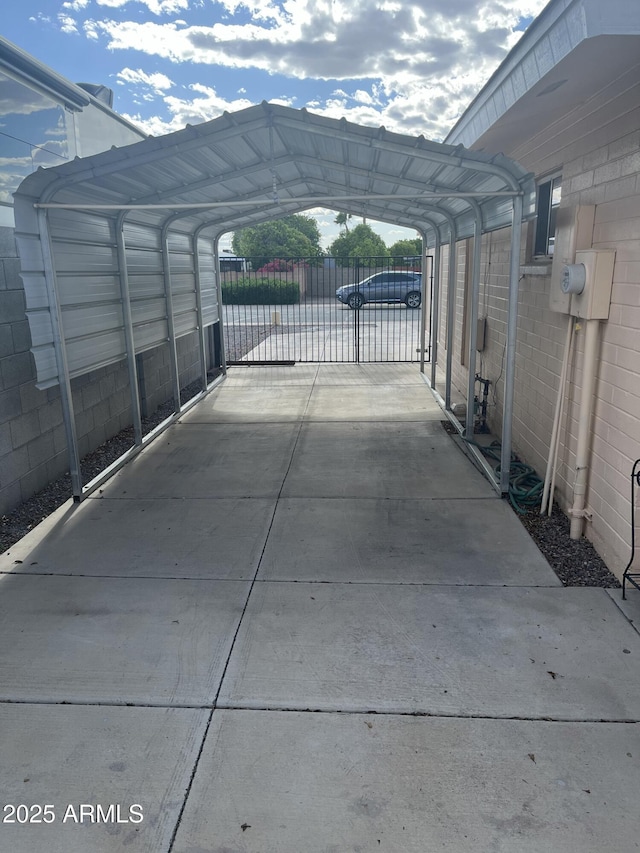 235 N 61st Pl, Mesa, AZ 85205 - view of parking / parking lot with a detached carport, concrete driveway, fence, and a gate