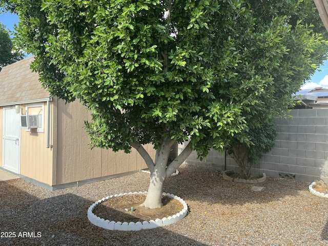 235 N 61st Pl, Mesa, AZ 85205 - view of side of property featuring fence, an outdoor structure, cooling unit, and a shed