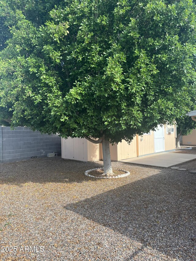 235 N 61st Pl, Mesa, AZ 85205 - view of yard featuring fence, a storage unit, and an outbuilding