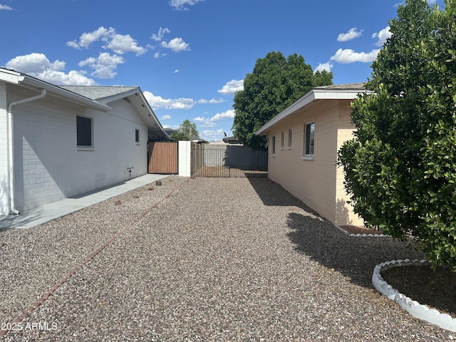 235 N 61st Pl, Mesa, AZ 85205 - view of property exterior featuring a gate, brick siding, and fence