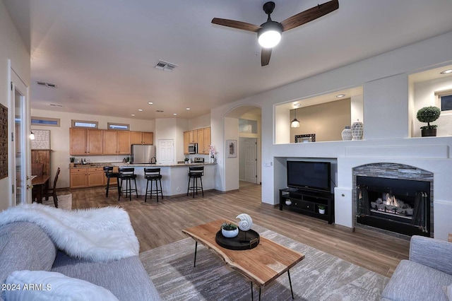 living room featuring hardwood / wood-style flooring and ceiling fan