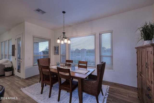 dining room featuring hardwood / wood-style floors and a notable chandelier