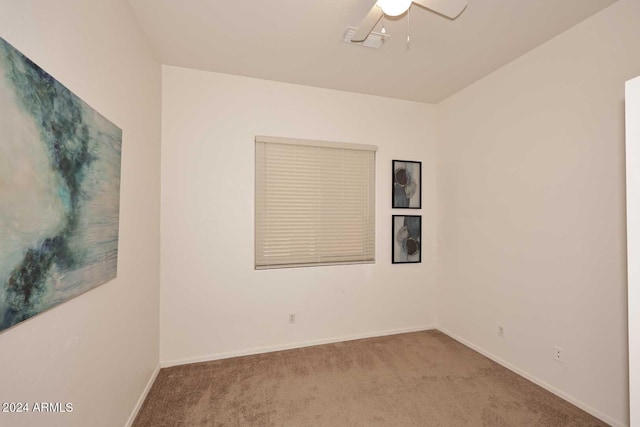 empty room with light colored carpet and ceiling fan