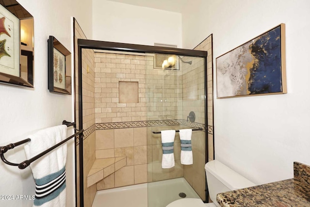 bathroom featuring an enclosed shower and toilet