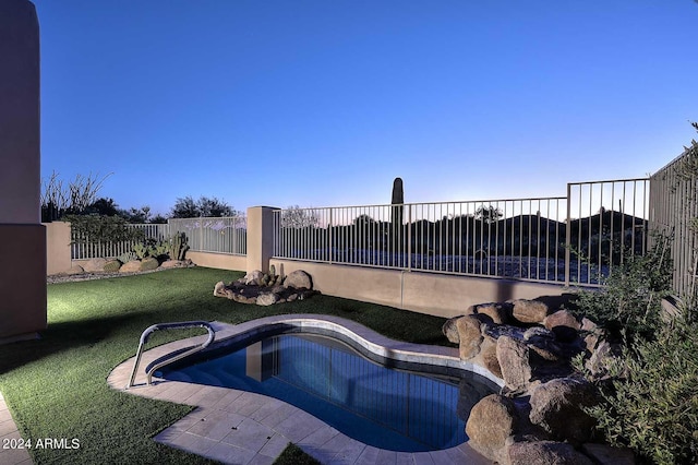 view of pool featuring a yard