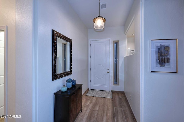 doorway with hardwood / wood-style flooring