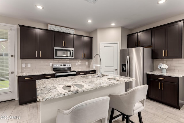 17437 W Via De Luna Dr, Surprise, AZ 85387 - kitchen with a sink, light wood finished floors, appliances with stainless steel finishes, and a healthy amount of sunlight