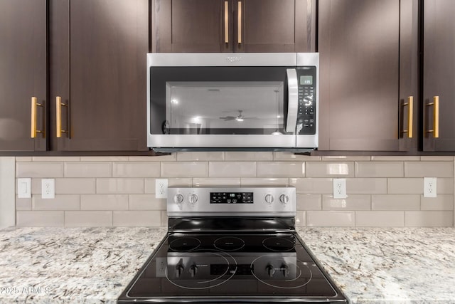 17437 W Via De Luna Dr, Surprise, AZ 85387 - kitchen with decorative backsplash, appliances with stainless steel finishes, and dark brown cabinetry