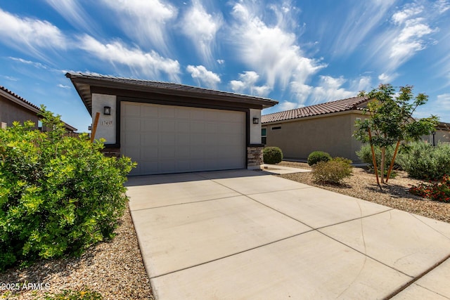 17437 W Via De Luna Dr, Surprise, AZ 85387 - view of front of house with an attached garage, stucco siding, a tiled roof, and concrete driveway
