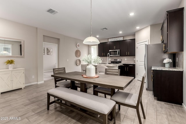 17437 W Via De Luna Dr, Surprise, AZ 85387 - dining room with recessed lighting, baseboards, light wood finished floors, and visible vents