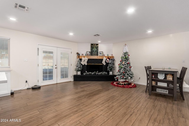 12043 N 46th Ave, Glendale, AZ 85304 - living room with wood finished floors, baseboards, french doors, a fireplace, and recessed lighting