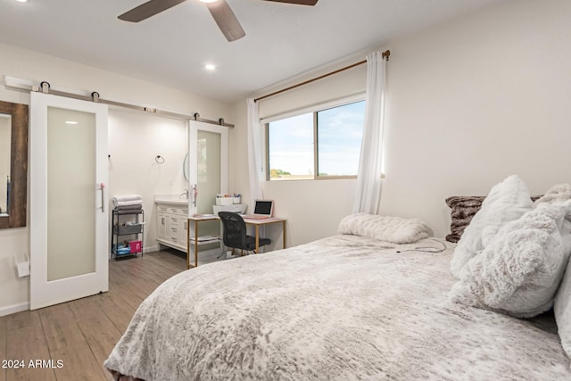 12043 N 46th Ave, Glendale, AZ 85304 - bedroom with wood finished floors, a barn door, baseboards, recessed lighting, and a ceiling fan