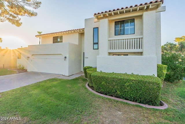 mediterranean / spanish home with a garage and a front yard