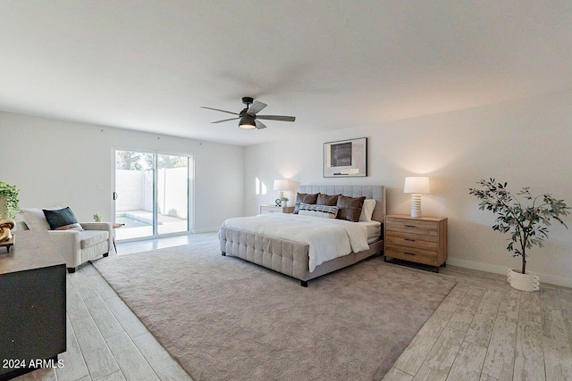 bedroom with light hardwood / wood-style floors, ceiling fan, and access to outside