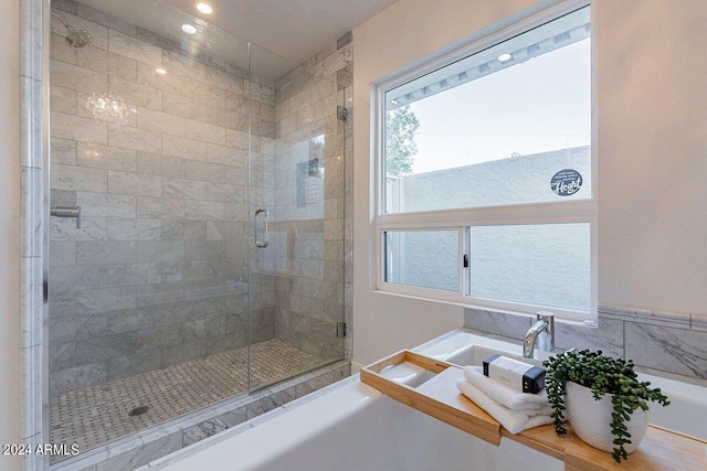 bathroom with a shower with door