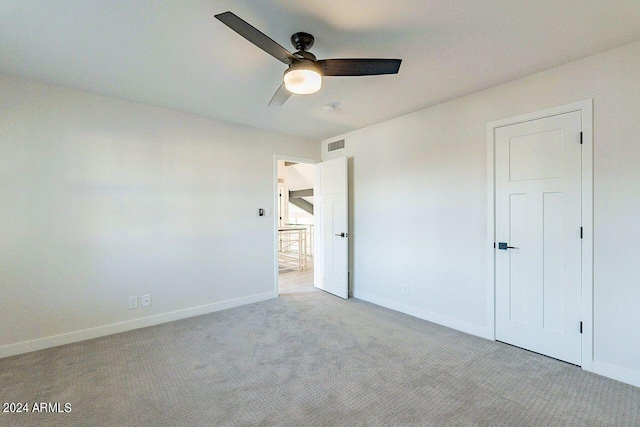 unfurnished bedroom with light carpet and ceiling fan