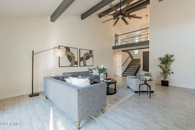 living room featuring ceiling fan, beamed ceiling, hardwood / wood-style floors, and high vaulted ceiling