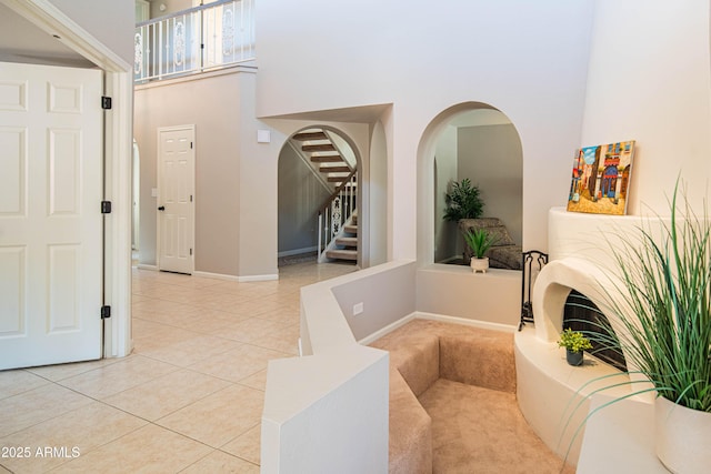 11025 N 10th St, Phoenix, AZ 85020 - entrance foyer featuring light tile patterned flooring, a high ceiling, stairs, and arched walkways