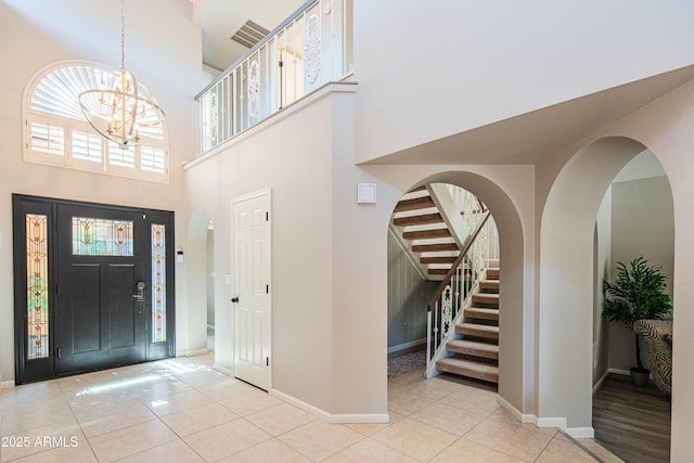 11025 N 10th St, Phoenix, AZ 85020 - tiled entrance foyer featuring a chandelier, a towering ceiling, stairway, and arched walkways