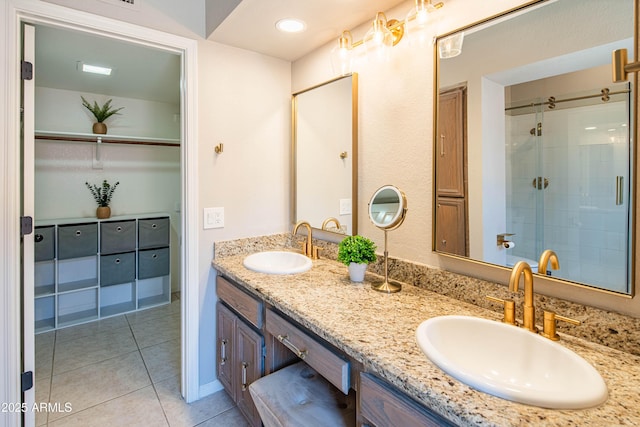 11025 N 10th St, Phoenix, AZ 85020 - full bathroom with double vanity, tile patterned floors, a stall shower, and a walk in closet