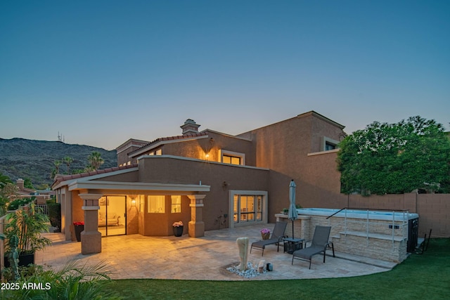 11025 N 10th St, Phoenix, AZ 85020 - back of house featuring a patio, stucco siding, and a chimney