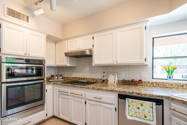 11025 N 10th St, Phoenix, AZ 85020 - kitchen featuring stainless steel double oven, dishwashing machine, black electric stovetop, white cabinets, and light stone countertops