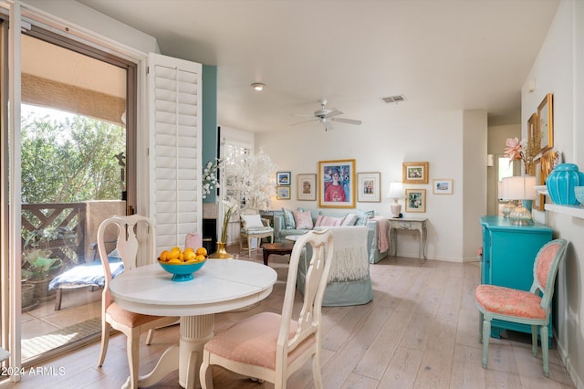 dining room with ceiling fan and light hardwood / wood-style floors