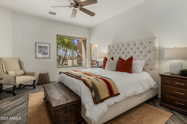 bedroom featuring ceiling fan, visible vents, and wood finished floors