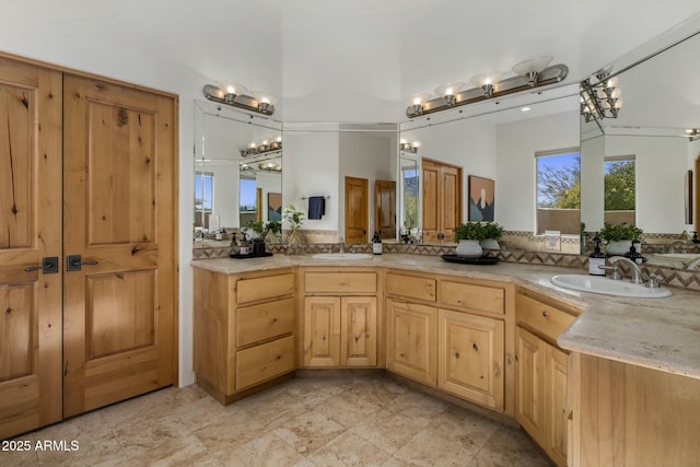 full bathroom featuring a sink and double vanity