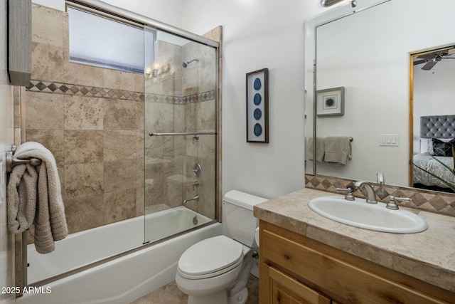 full bathroom with shower / bath combination with glass door, connected bathroom, vanity, and toilet