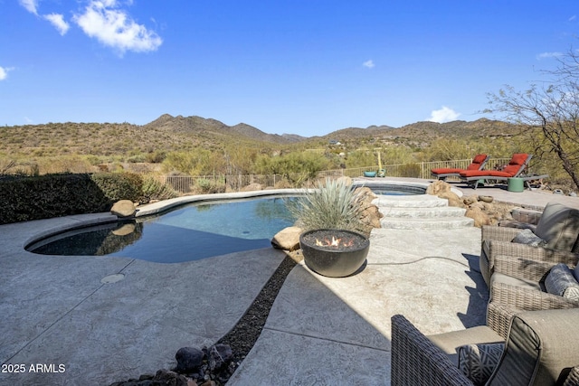 view of swimming pool featuring a mountain view, an in ground hot tub, fence, a fenced in pool, and a patio area