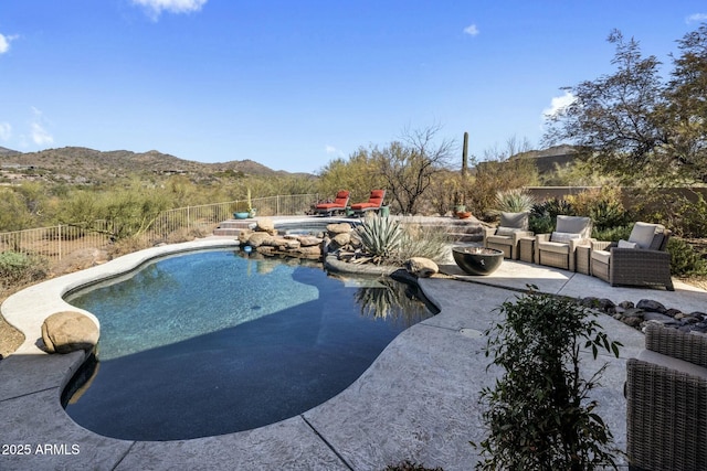 view of swimming pool featuring a fenced in pool, a fenced backyard, a patio, and a mountain view