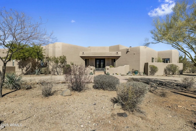 view of front of property featuring french doors and stucco siding