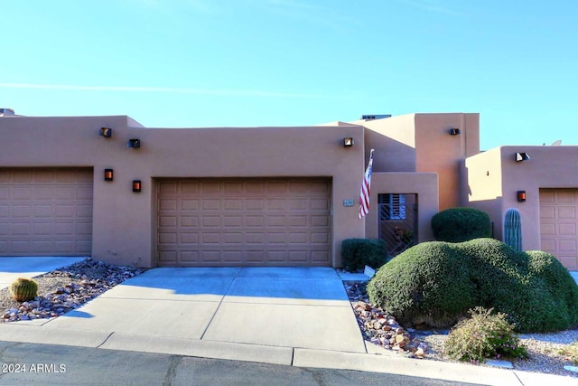 pueblo-style house with a garage