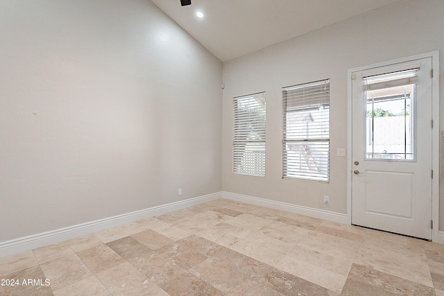 spare room with vaulted ceiling