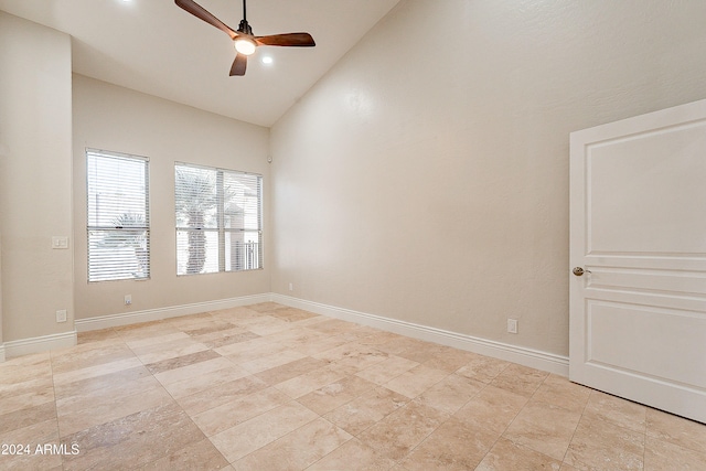 spare room with ceiling fan and high vaulted ceiling