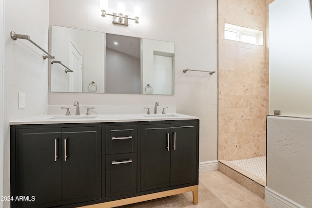 bathroom featuring tile patterned floors, vanity, and tiled shower