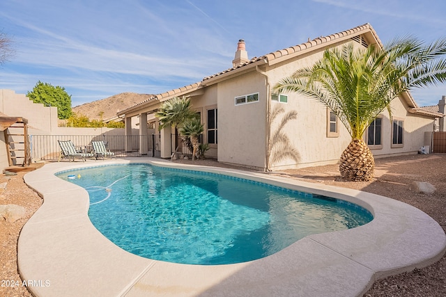 view of pool with a patio area and a mountain view