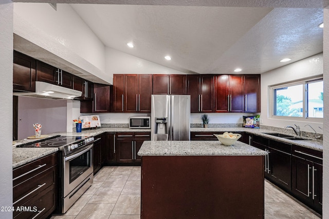 kitchen featuring vaulted ceiling, a center island, appliances with stainless steel finishes, sink, and light tile floors