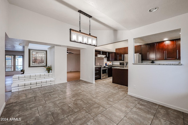 kitchen with stainless steel appliances, kitchen peninsula, dark brown cabinets, decorative light fixtures, and light tile floors