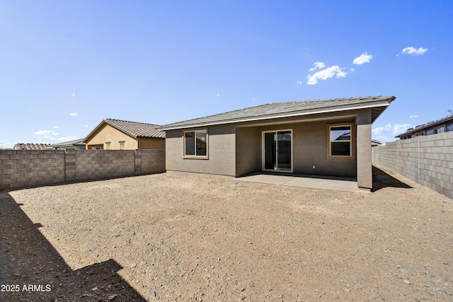 back of house featuring a patio, a fenced backyard, and stucco siding