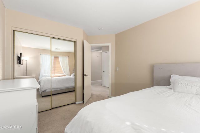 bedroom with light carpet and a closet