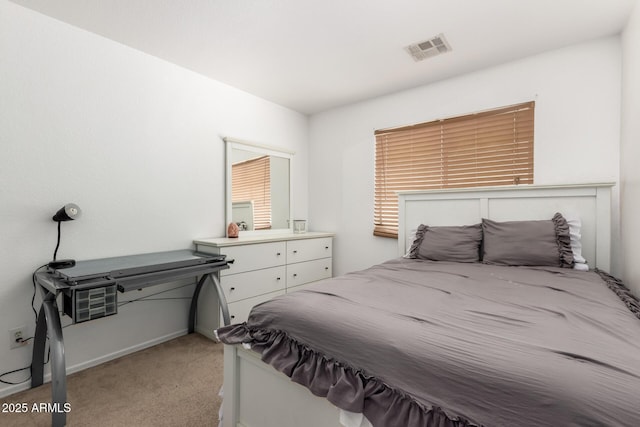 bedroom featuring visible vents and light carpet