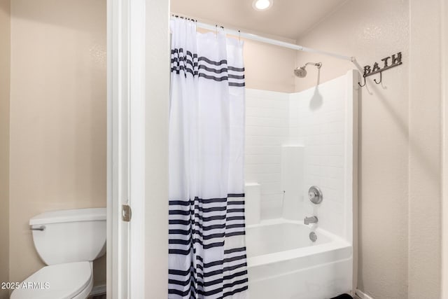 bathroom with shower / bath combo and toilet