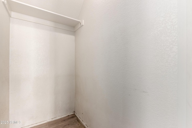 walk in closet featuring wood finished floors