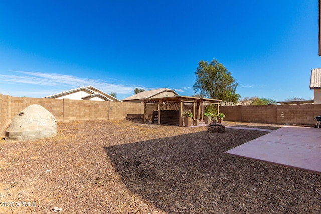 view of yard featuring a patio, an outdoor fire pit, an outdoor structure, and a fenced backyard